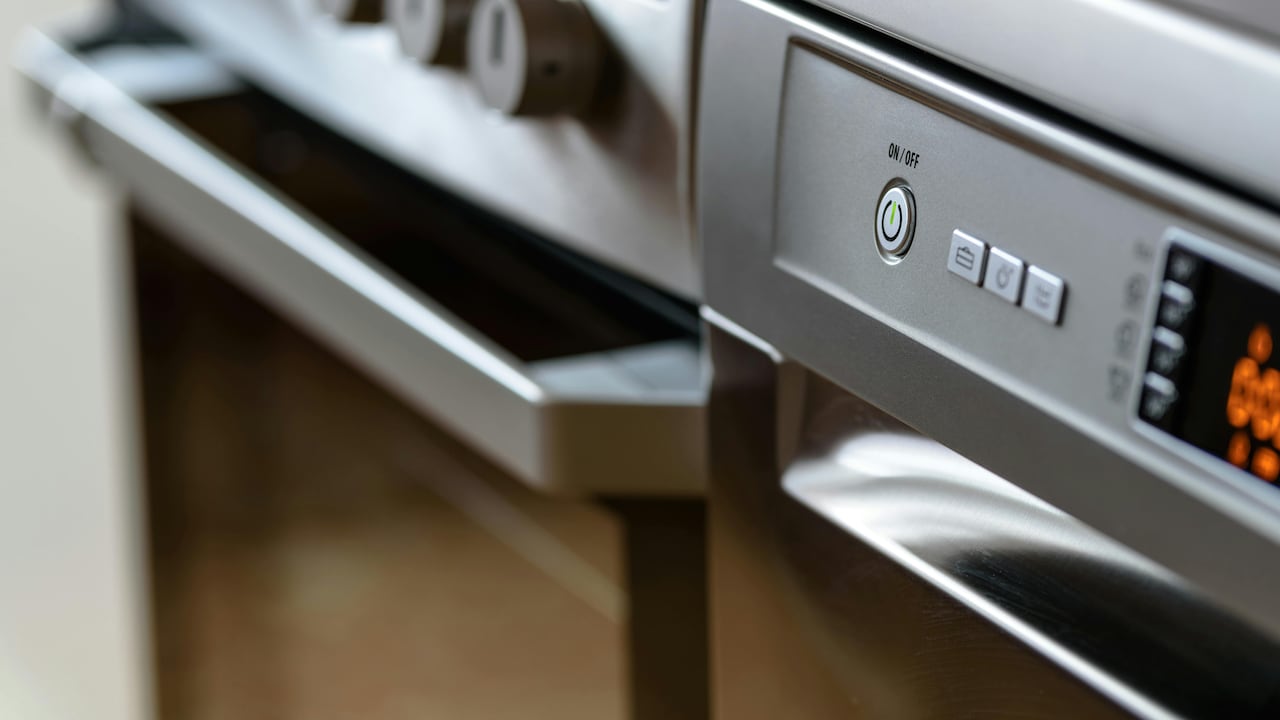 A sleek dishwasher integrated into a modern Indian modular kitchen.