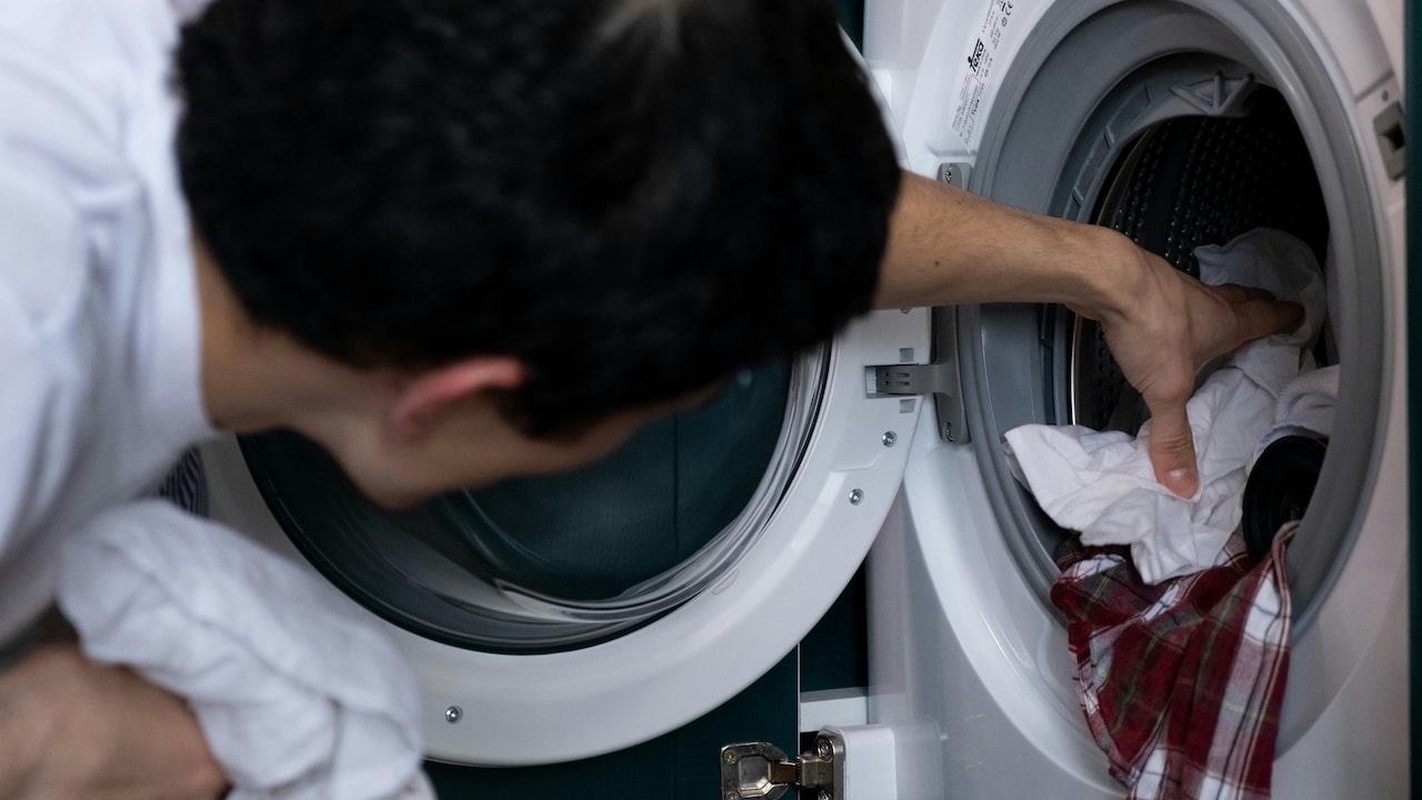 Washing machine drum filled with clothes ready for a hot wash cycle.