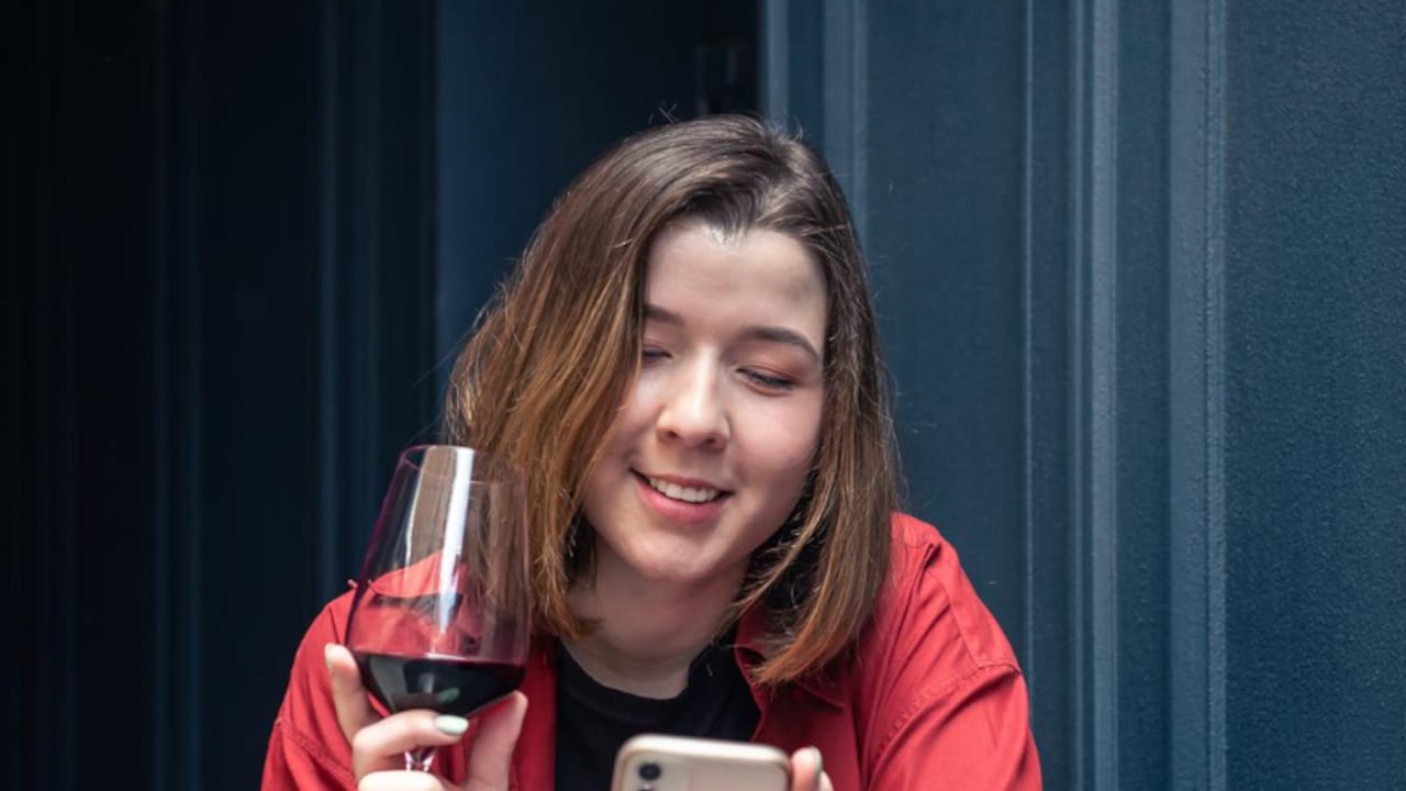 A Woman Drinking Black Water, Suggesting Its A Functional Hydration Choice.