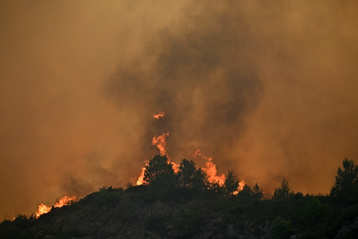 A forest is engulfed in flames as a wildfire rages near Fontjoncouse, southwestern France A forest is engulfed in flames as a wildfire rages near Fontjoncouse, southwestern France
