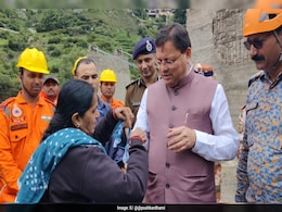 Gujarat Woman Tears Dupatta, Ties It As Rakhi To Uttarakhand Chief Minister During Flood Inspection Gujarat Woman Tears Dupatta, Ties It As Rakhi To Uttarakhand Chief Minister During Flood Inspection