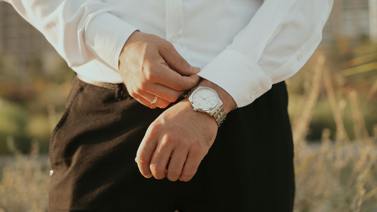 Use the military pinch the excess fabric at the side seams and fold it back before tucking in.