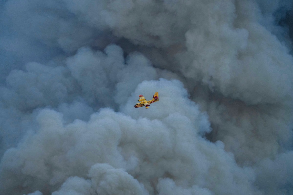 A Canadair CL-415 of the French civil security flies over a wildfire in Jonquieres, southwestern France A Canadair CL-415 of the French civil security flies over a wildfire in Jonquieres, southwestern France