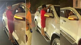 Danger Stunt: चलती कार में बेटे से खतरनाक स्टंट करा रहा था पिता, पुलिस ने पकड़ा तो कान पकड़ कर मांगने लगा माफी