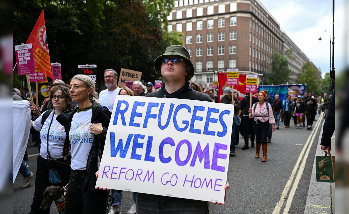 Members of the campaign group, Stand Up to Racism, demonstrate against a rally organised by the British anti-immigration activist Stephen Yaxley-Lennon (Reuters) Members of the campaign group, Stand Up to Racism, demonstrate against a rally organised by the British anti-immigration activist Stephen Yaxley-Lennon (Reuters)