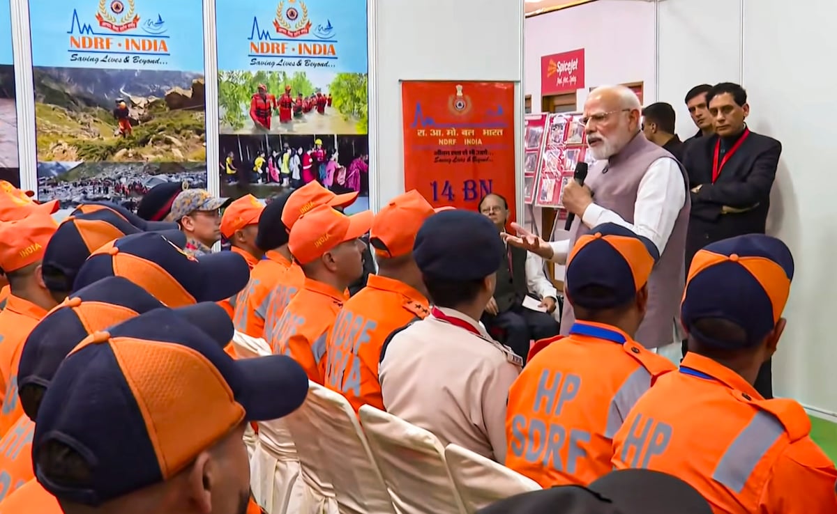 PM Modi interacts with members of NDRF, SDRF and Aapda Mitra team in Kangra during his visit to Himachal Pradesh. PM Modi interacts with members of NDRF, SDRF and Aapda Mitra team in Kangra during his visit to Himachal Pradesh.