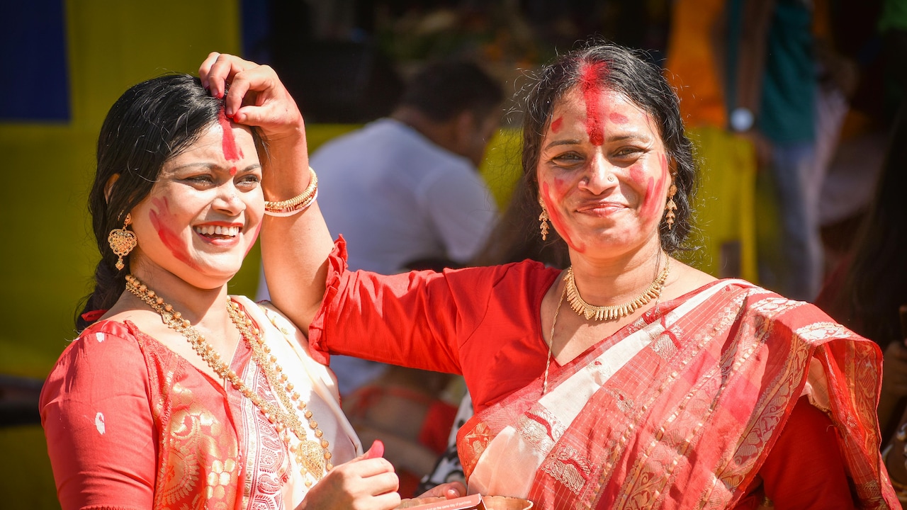 Women wear traditional red-and-white sarees, symbolising strength and purity.
