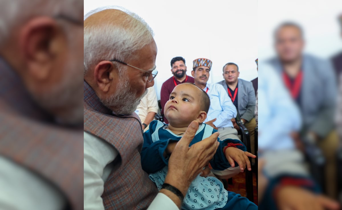 PM Modi met 11-month-old Neetika, the lone survivor of her family in the floods, during his visit to Himachal. PM Modi met 11-month-old Neetika, the lone survivor of her family in the floods, during his visit to Himachal.