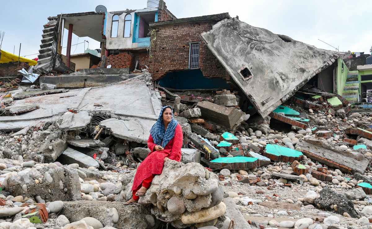 A woman sitting outside her home that was destroyed by recent floods in Jammu and Kashmir. A woman sitting outside her home that was destroyed by recent floods in Jammu and Kashmir.