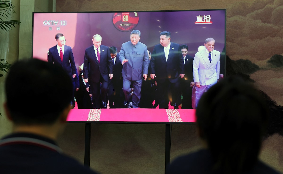 A TV screen shows Chinese President Xi Jinping, Russian President Vladimir Putin and North Korean leader Kim Jong Un arriving for a military parade. A TV screen shows Chinese President Xi Jinping, Russian President Vladimir Putin and North Korean leader Kim Jong Un arriving for a military parade.