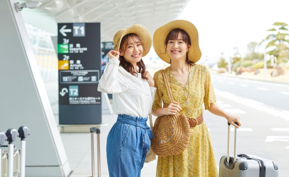 Women standing outside an airport. Women standing outside an airport.
