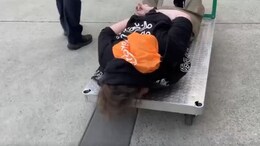 On Camera, Protester Handcuffed, Wheeled Away On Metal Cart By US Officials