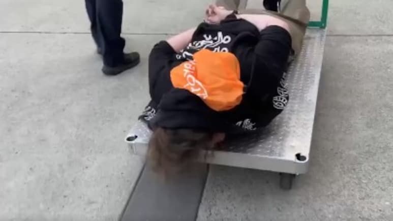 On Camera, Protester Handcuffed, Wheeled Away On Metal Cart By US Officials