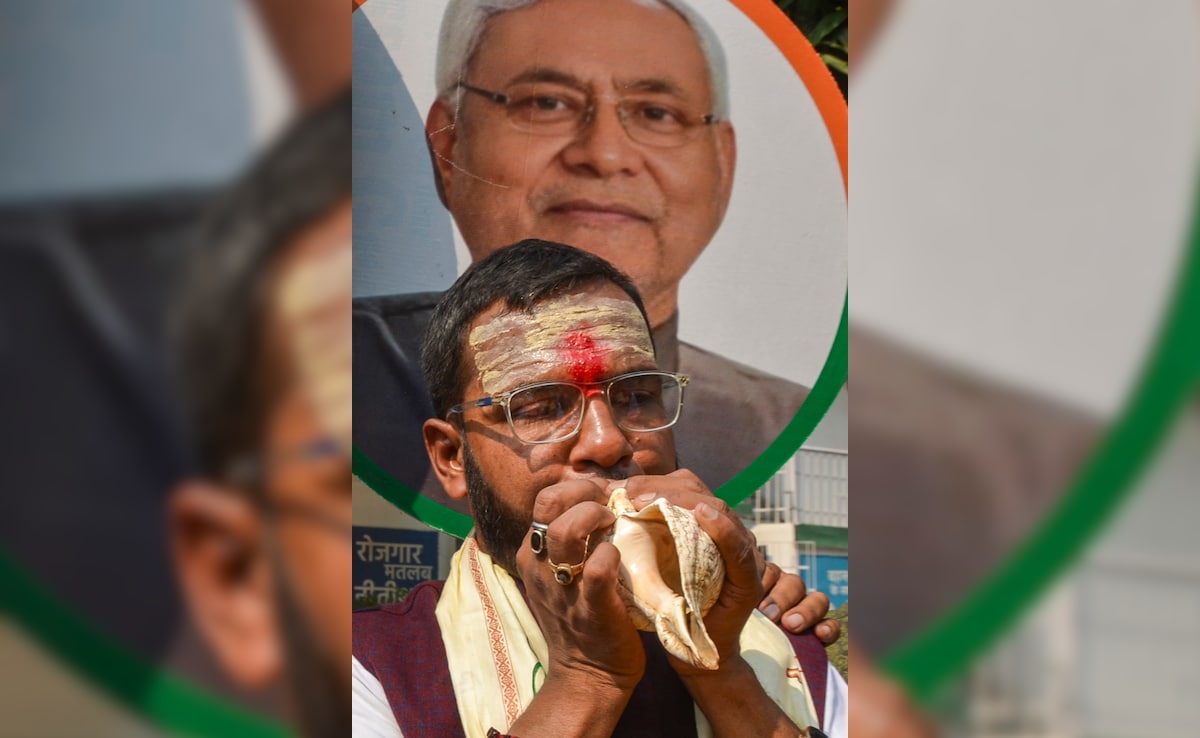 A person blows a conch shell during celebrations as the NDA leads in Bihar elections. PTI