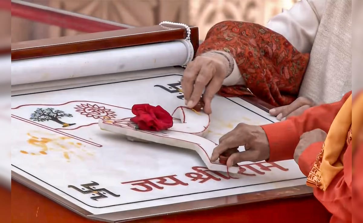 It features the image of a radiant Sun, the sacred symbol Om, and the Kovidara tree. PTI