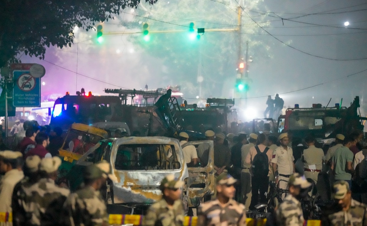 Security personnel at the spot after a blast occurred in a car near Red Fort Security personnel at the spot after a blast occurred in a car near Red Fort
