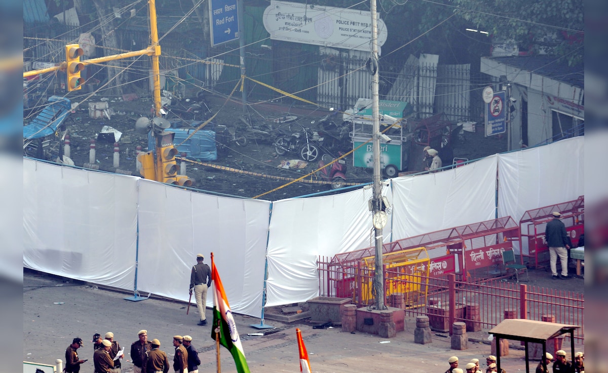 The area near the car blast site has been covered with white cloth where charred remains are scattered. PTI