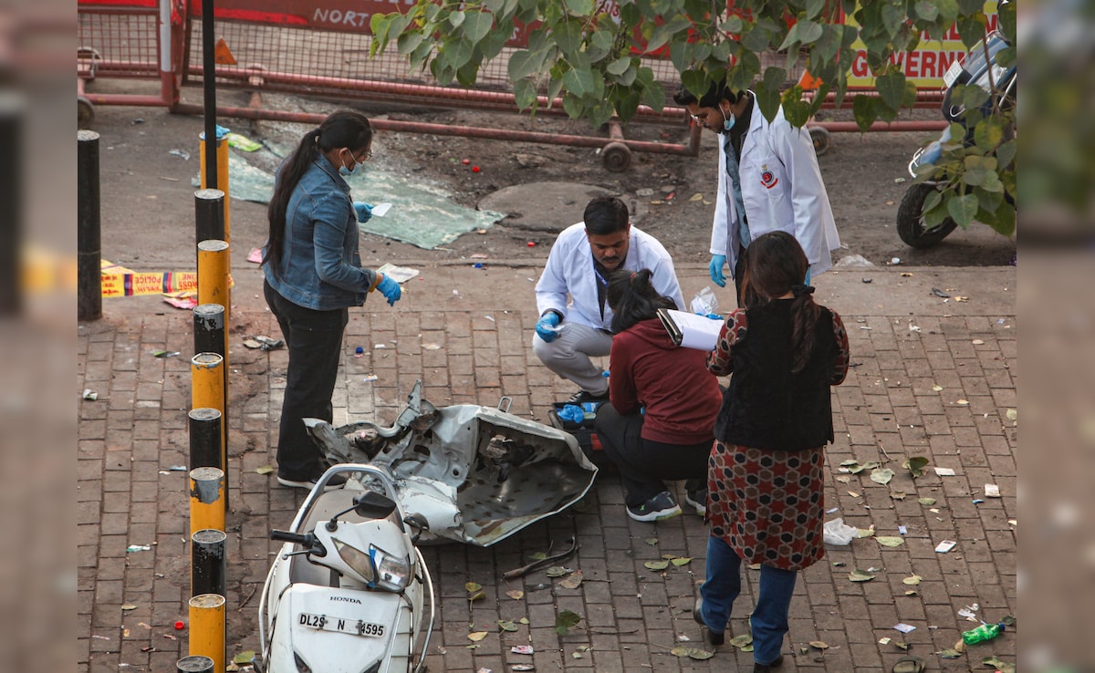 Forensic officials collect samples from the site in the aftermath of the blast. PTI