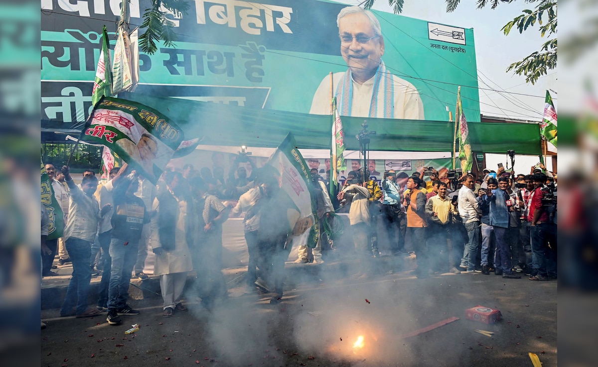 JDU supporters burst firecrackers in Patna as NDA crosses majority mark in Bihar polls. PTI
