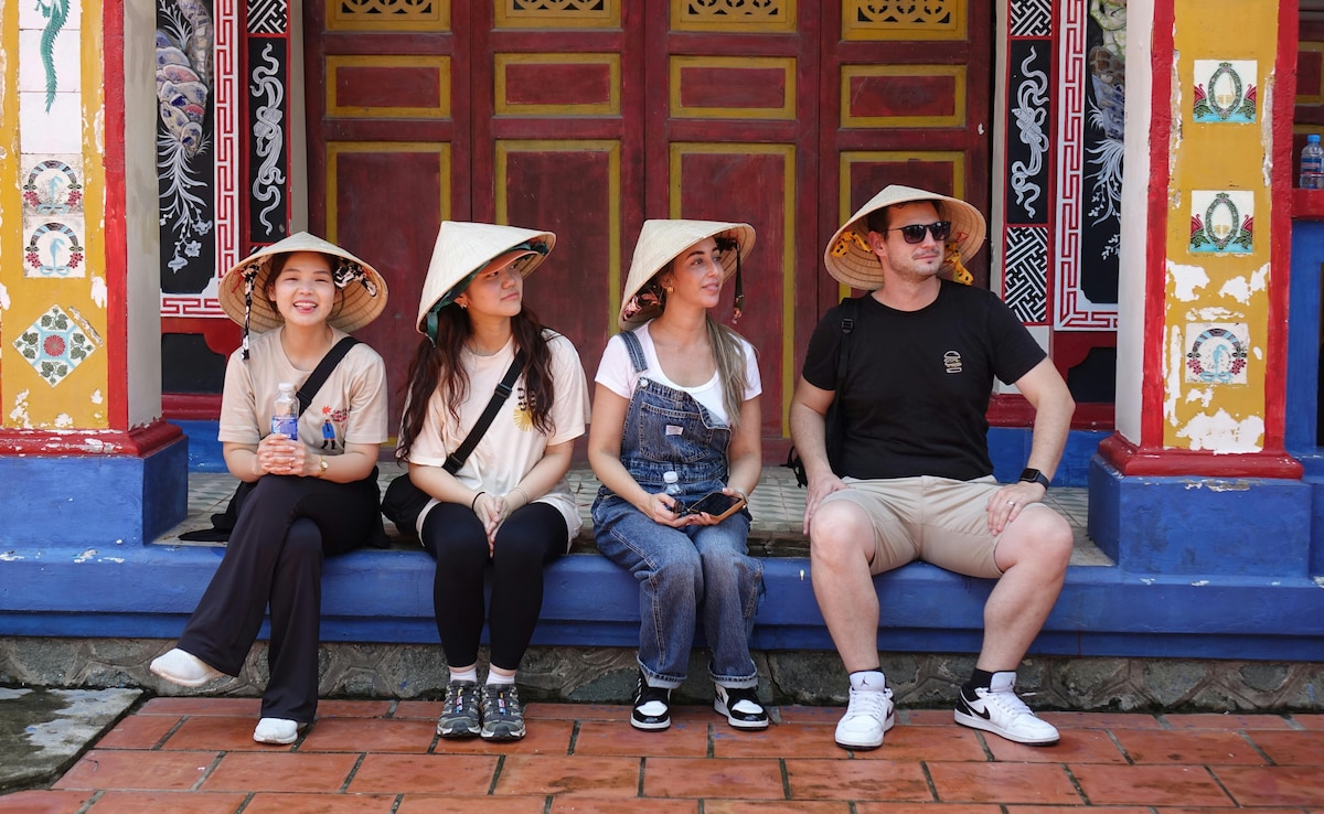 Tourists Wearing Traditional Hats at Vibrant Temple