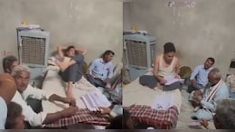 रजवाडे़ की तरह खाट पर लेटा पटवारी, लोगों को जमीन पर बैठाया; पैसा लेने का वीड&zwj;ियो वायरल