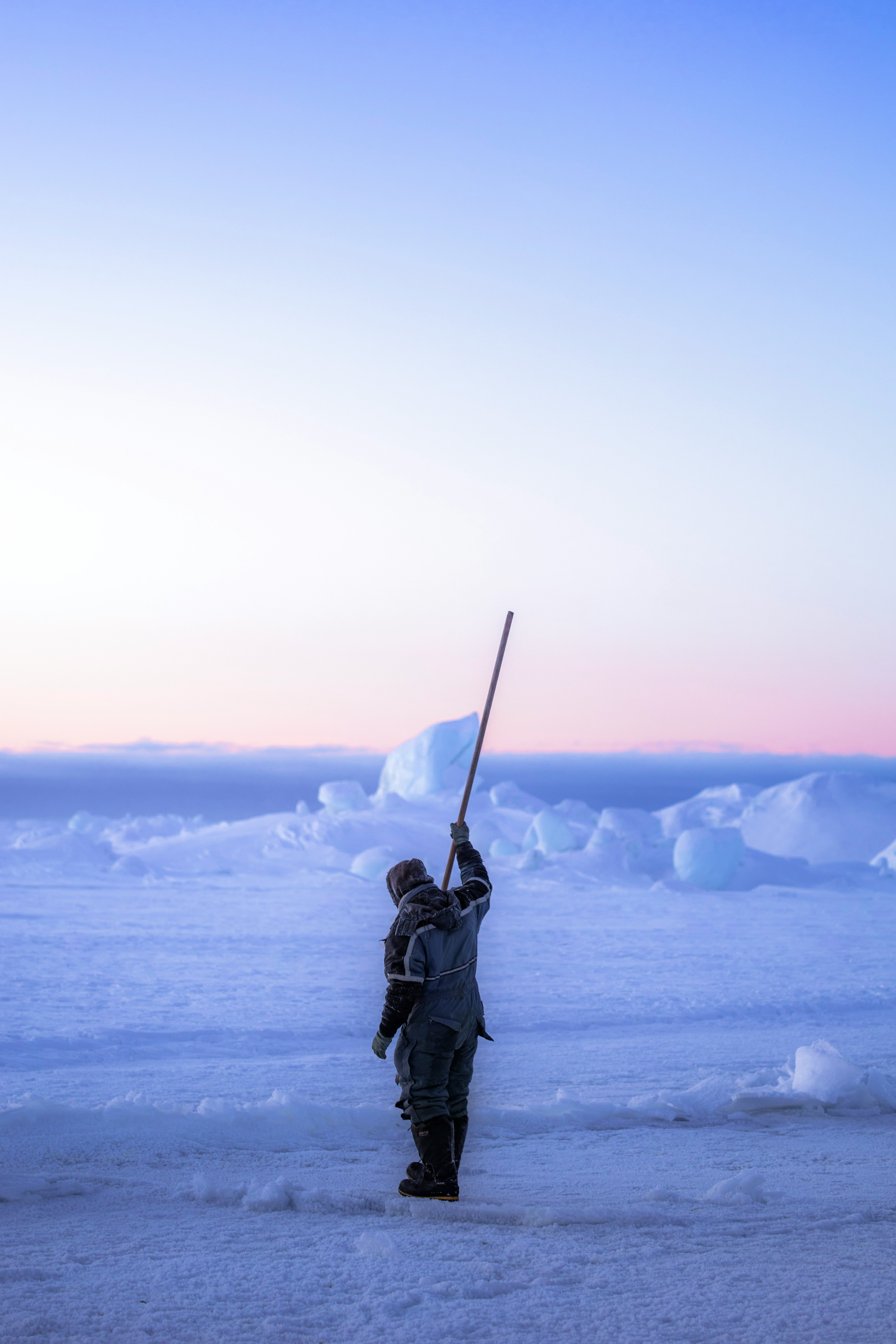 Sea ice fisherman checking the sea ice if it is safe. Photo: Unsplash Sea ice fisherman checking the sea ice if it is safe. Photo: Unsplash