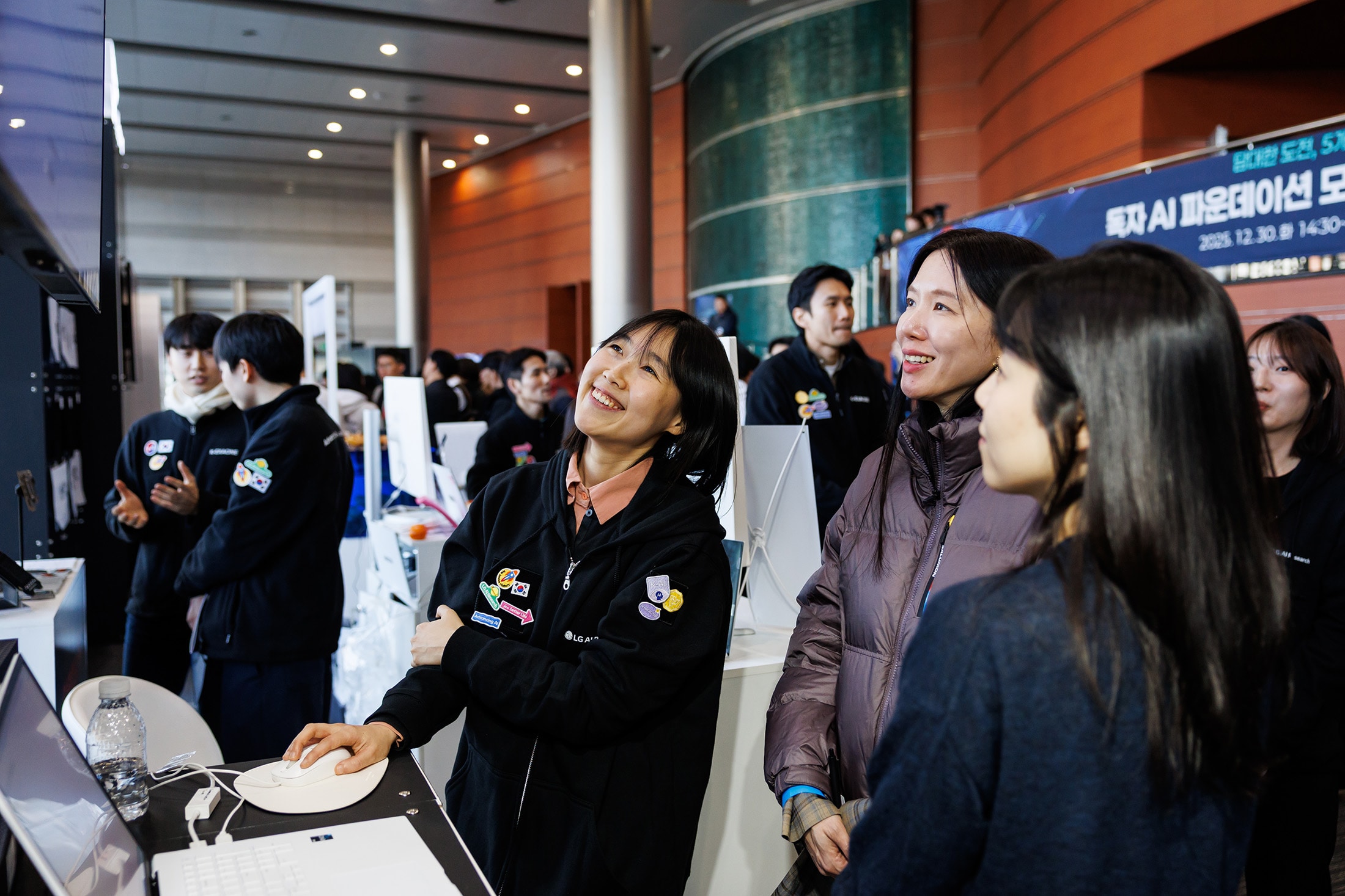 Visitors try AI models at an LG AI Research booth at the December event. Photographer: SeongJoon Cho/Bloomberg