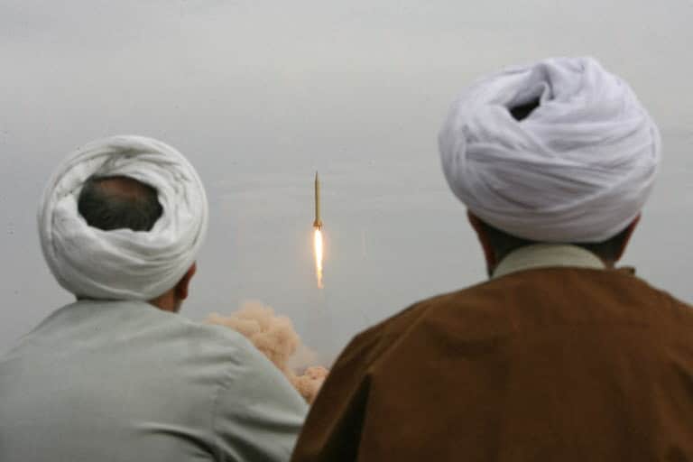 Iranian clergymen watch a Shahab-3 long-range ballistic missile fird by Irans Revolutionary Guards in the desert outside the holy city of Qom, 02 November 2006