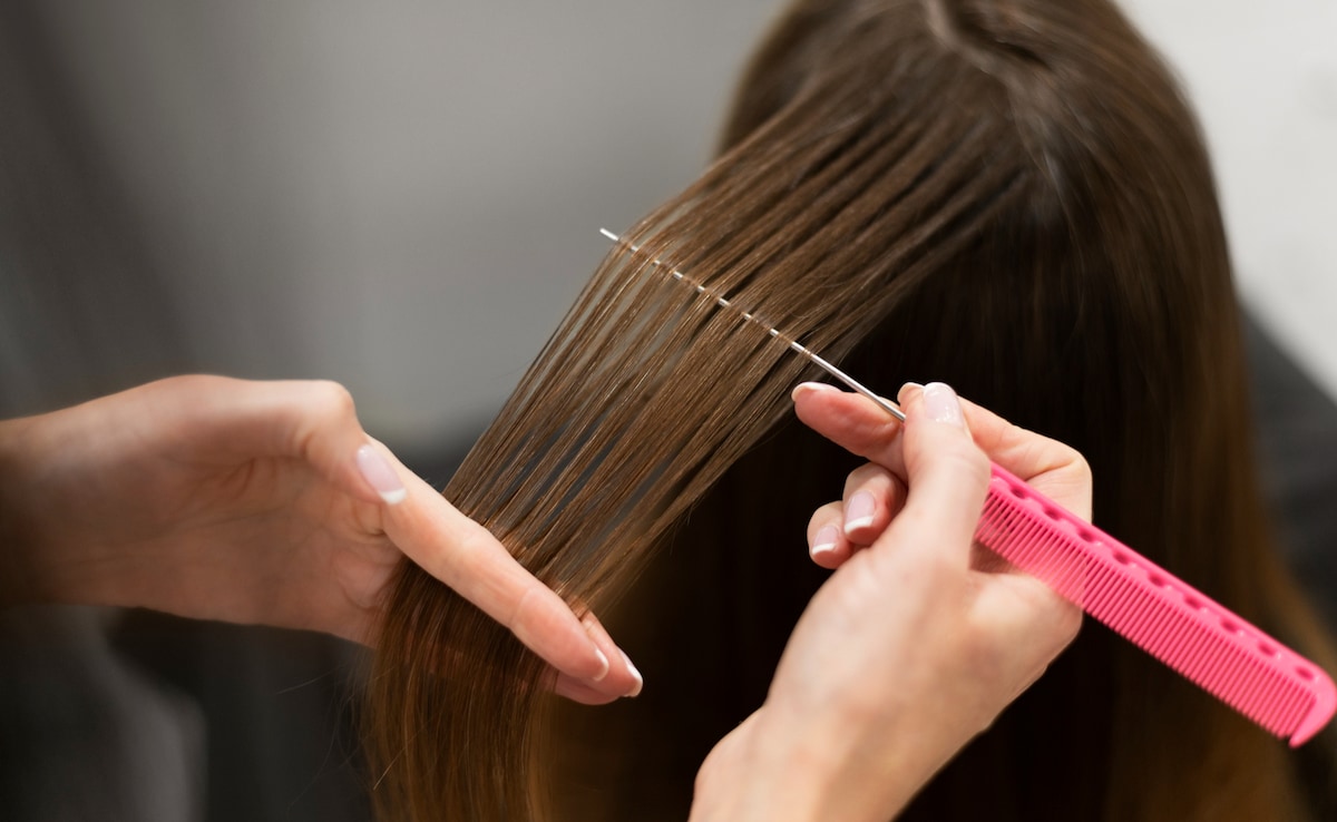 Hair extensions being weaved into natural hair