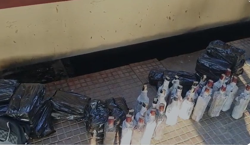 ट्रेन की बोगी के नीचे से निकली शराब की बोतलें. ट्रेन की बोगी के नीचे से निकली शराब की बोतलें.