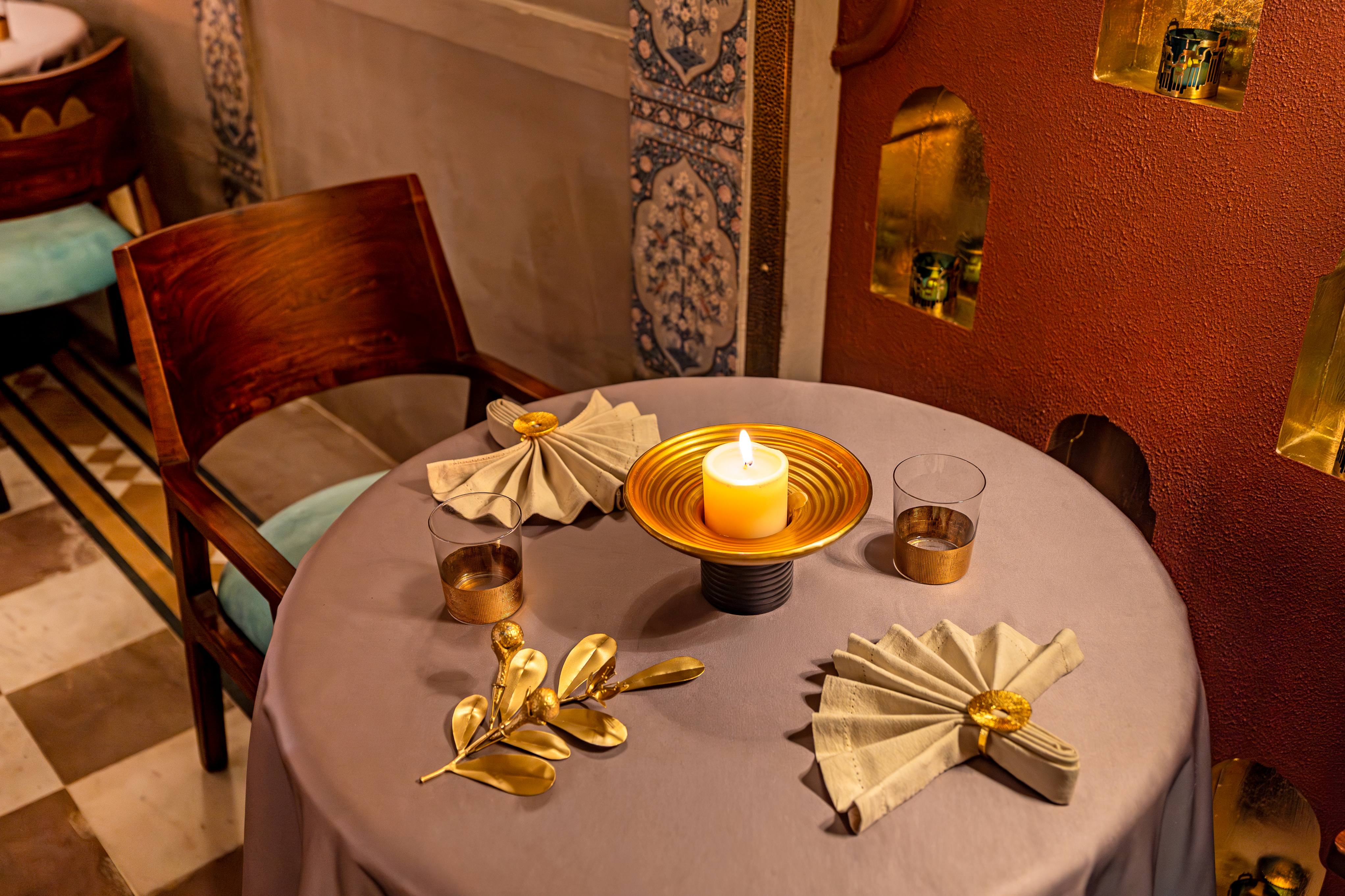 As we took our seats in the newly furnished courtyard, a single candle was lit on the table