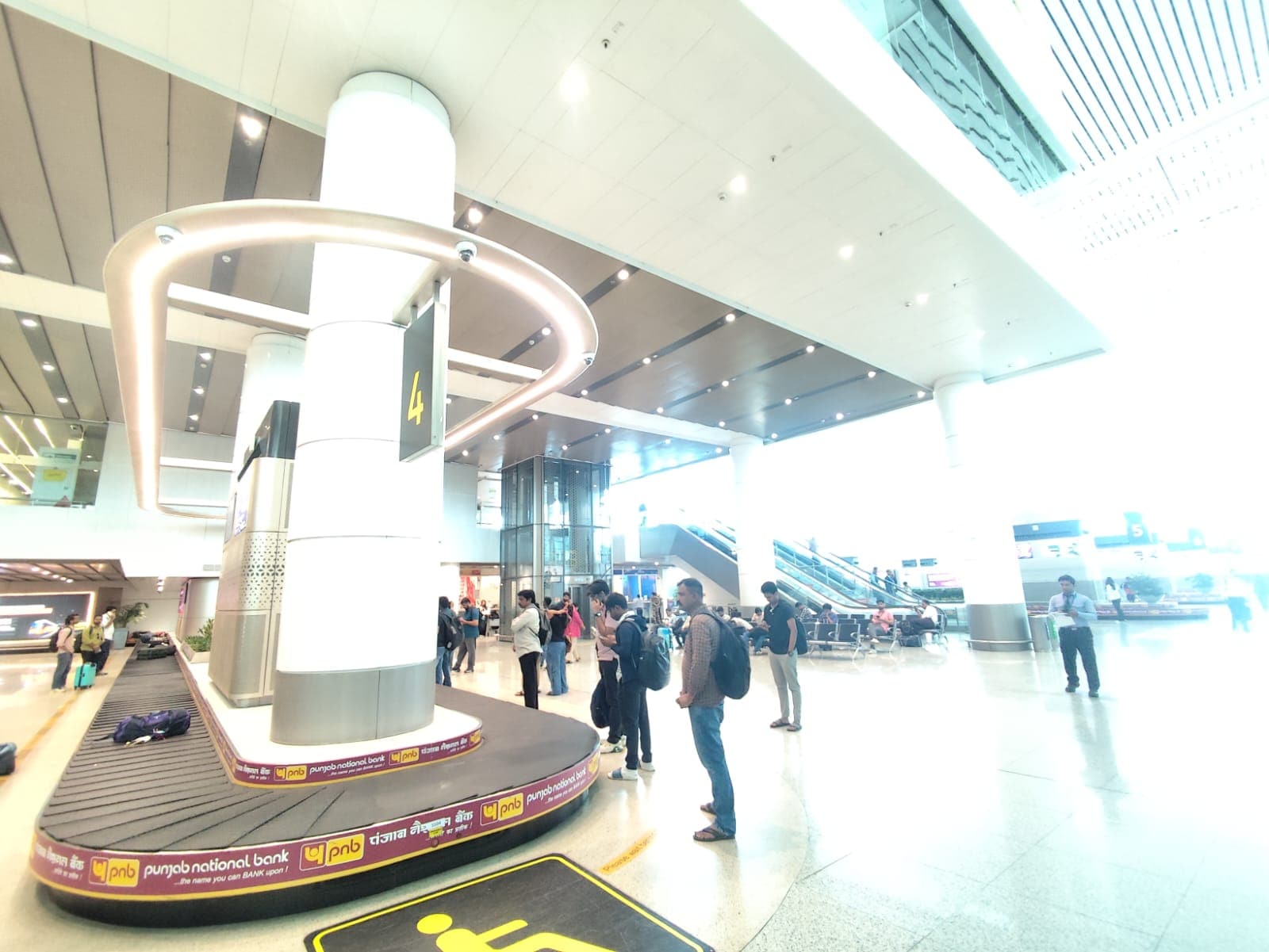 The IndiGo Airlines passengers waiting for their luggage at the Delhi Airport.