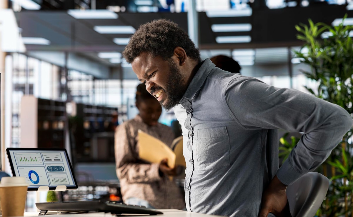 A person feeling lower back pain