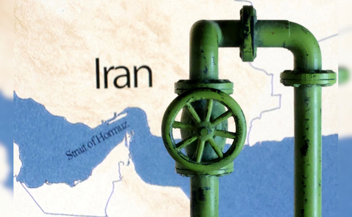 A map showing the Strait of Hormuz and Iran is seen behind a 3D printed oil pipeline. (Reuters)