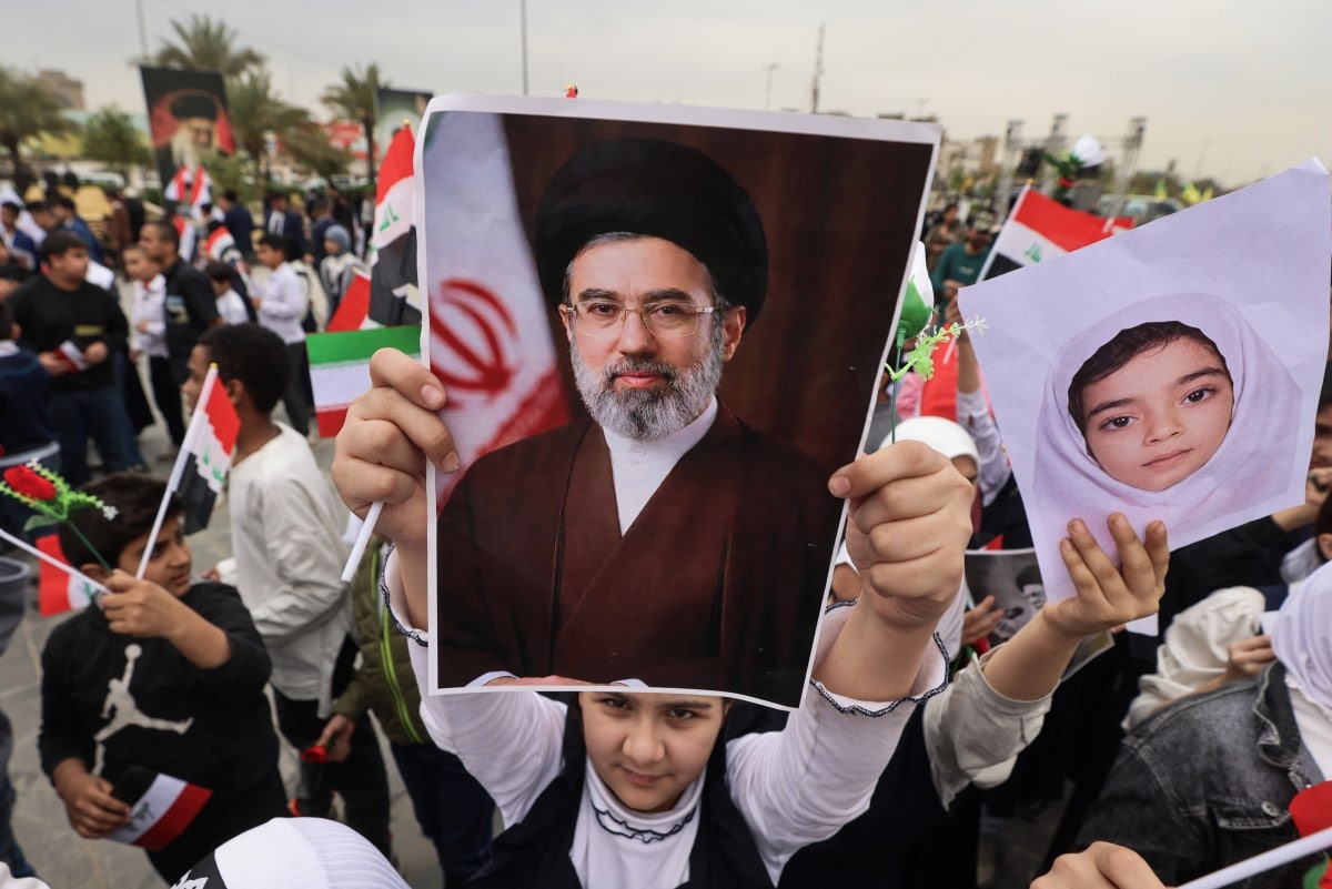 A schoolgirl holds up a poster of Irans new supreme leader Mojtaba Khamenei during an anti-US and Israel demonstration in Baghdad on March 12, 2026