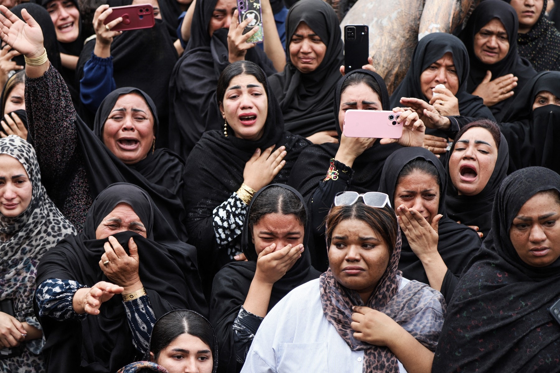 Mourners cry during the funeral of children killed in a reported strike on a primary school in Iran's Hormozgan province, in Minab on March 3, 2026