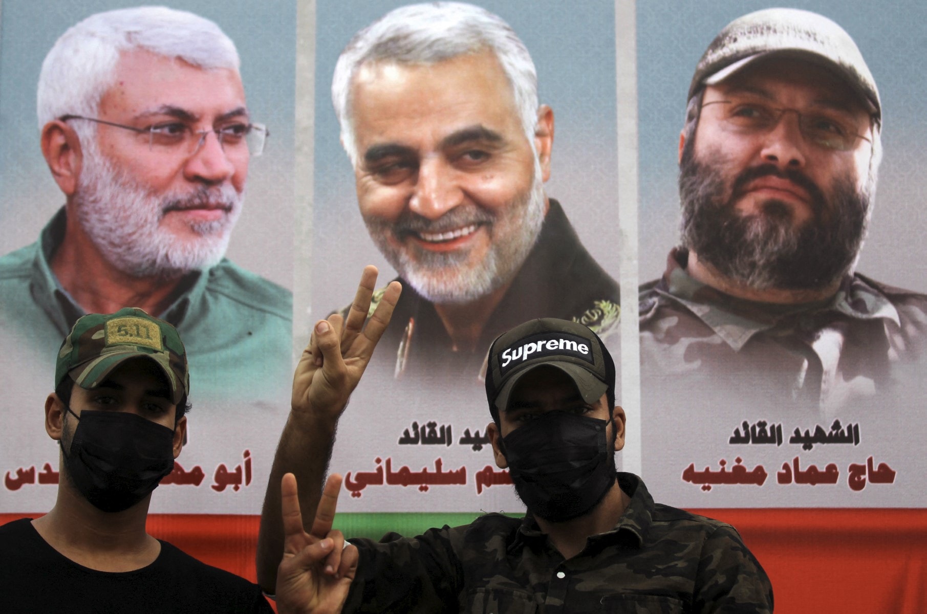 (L to R) Iraqi paramilitary commander Abu Mahdi al-Muhandis, Iranian commander Qasem Soleimani, and Lebanese Hezbollah commander Imad Mughniyeh during a demonstration outside the entrance to the Iraqi capital Baghdads highly-fortified Green Zone on November 7, 2020, demanding the departure of remaining US forces from Iraq.