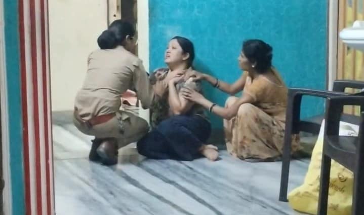 बेटियों की मौत पर बिलखती मां को संभालती महिला पुलिसकर्मी.