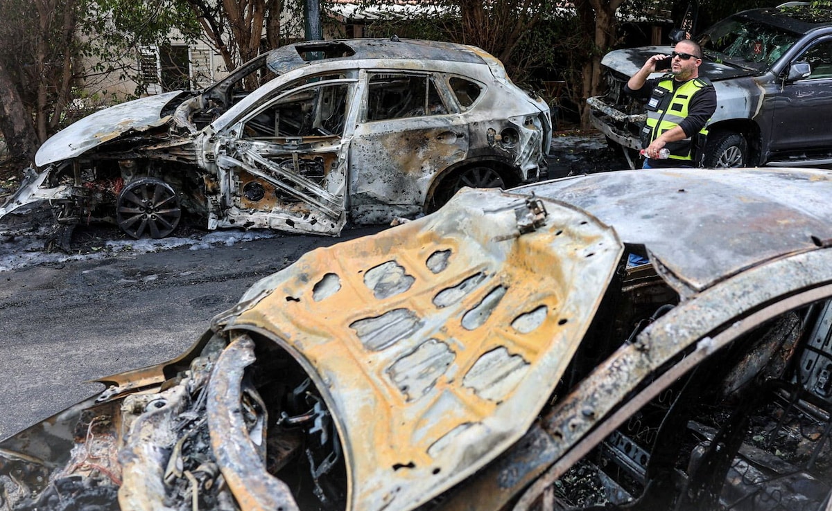Burnt out cars at the site where damage was caused following the launch of barrages of Iranian missiles towards Israel Burnt out cars at the site where damage was caused following the launch of barrages of Iranian missiles towards Israel