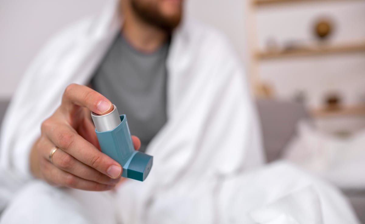 An asthmatic patient using an inhaler