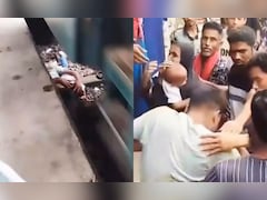 Dramatic Video Shows Man Shielding Son On Track As Train Passes Over Them