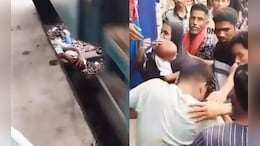 Dramatic Video Shows Man Shielding Son On Track As Train Passes Over Them
