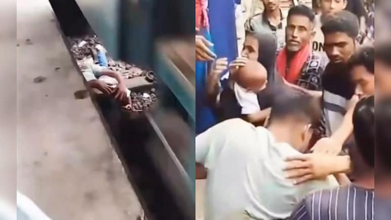 Dramatic Video Shows Man Shielding Son On Track As Train Passes Over Them