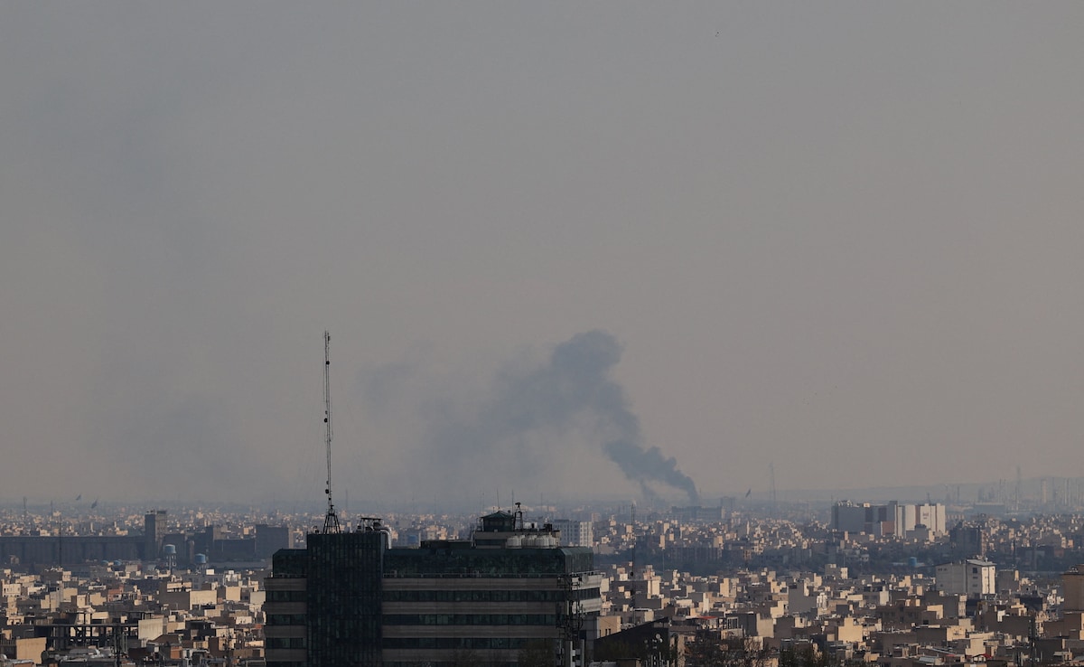 Smoke rises following a strike in Tehran Smoke rises following a strike in Tehran
