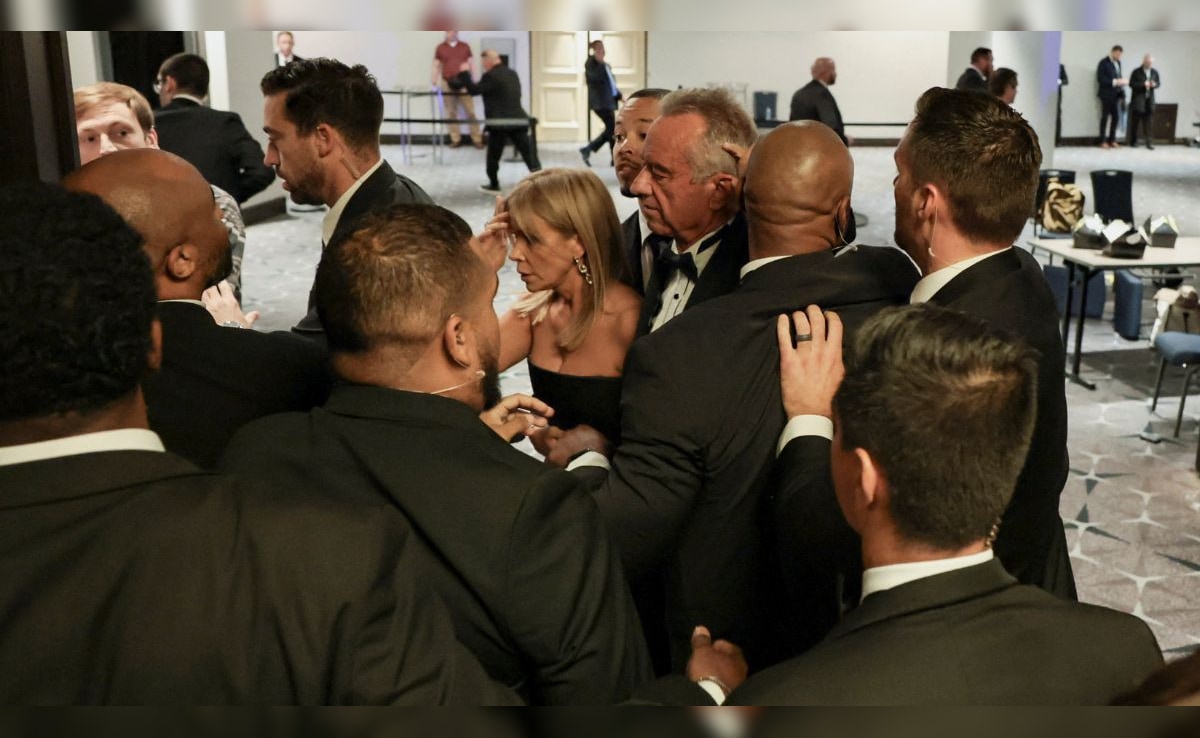 Robert F Kennedy Jr and his wife being escorted out of the venue.