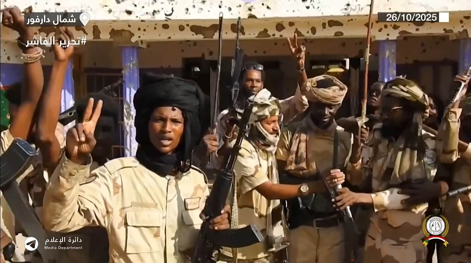 This image grab taken from handout video footage released on Sudans paramilitary Rapid Support Forces (RSF) Telegram account on October 26, 2025, shows RSF fighters holding weapons and celebrating in the streets of El-Fasher in Sudans Darfur.