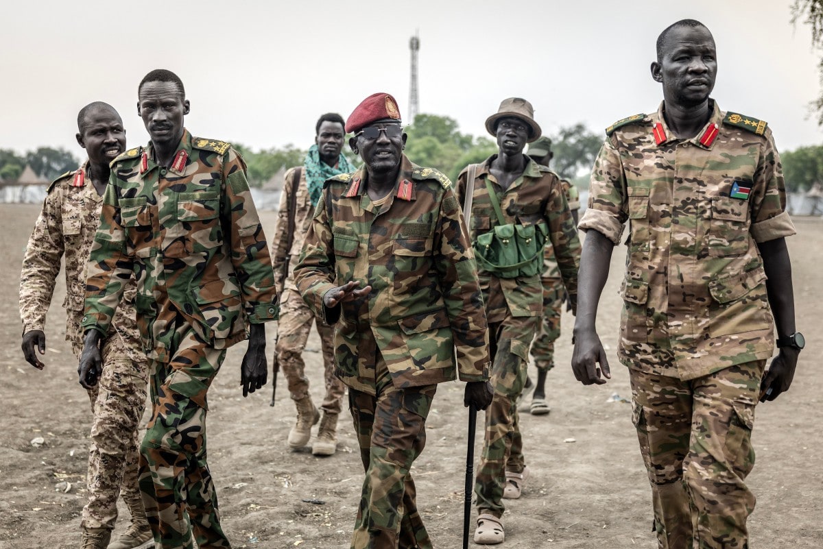 Members of the South Sudan People's Liberation Army in Opposition (SPLA-IO) surround a general as they walk toward their base in the strategic opposition-controlled town of Akobo, Jonglei State, on February 12, 2026. Members of the South Sudan People's Liberation Army in Opposition (SPLA-IO) surround a general as they walk toward their base in the strategic opposition-controlled town of Akobo, Jonglei State, on February 12, 2026.