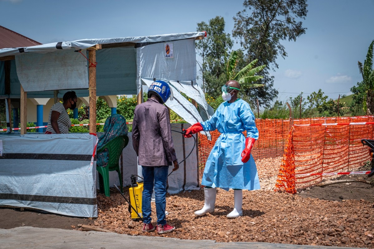 Dieudonné Sezabo, a health worker, decontaminates the clothing of a motorcycle taxi driver who transported a patient suspected of having Ebola to the Rwampara Hospital in Ituri, in the eastern Democratic Republic of the Congo, on May 26, 2026. Dieudonné Sezabo, a health worker, decontaminates the clothing of a motorcycle taxi driver who transported a patient suspected of having Ebola to the Rwampara Hospital in Ituri, in the eastern Democratic Republic of the Congo, on May 26, 2026.