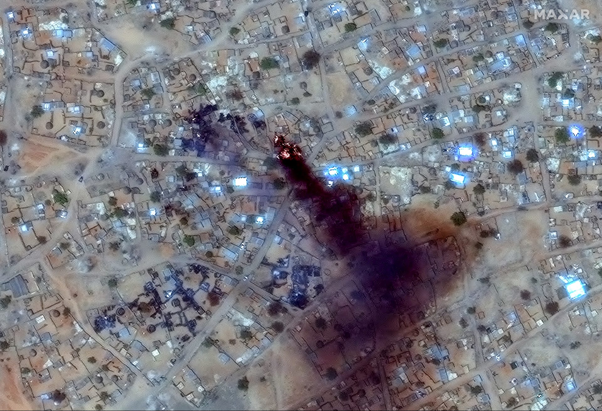 This handout image courtesy of Maxar Technologies taken on April 16, 2025 and released on April 17, 2025, shows fire and smoke at Zamzam camp near the besieged Darfur city of El-Fasher.