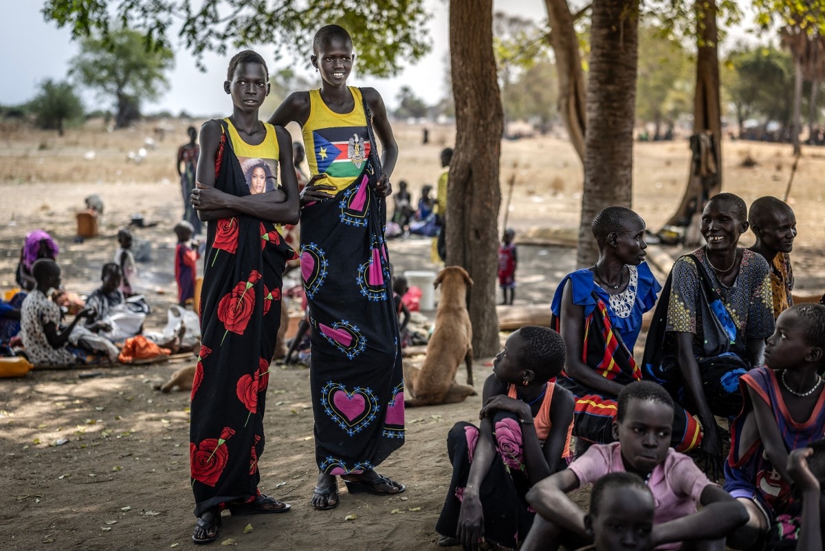 Girls from the Dinka community gather under the shade of a tree at an informal site where displaced people have assembled without assistance or shelter at Yolakot informal camp near Mingkaman, on February 14, 2026. Girls from the Dinka community gather under the shade of a tree at an informal site where displaced people have assembled without assistance or shelter at Yolakot informal camp near Mingkaman, on February 14, 2026.